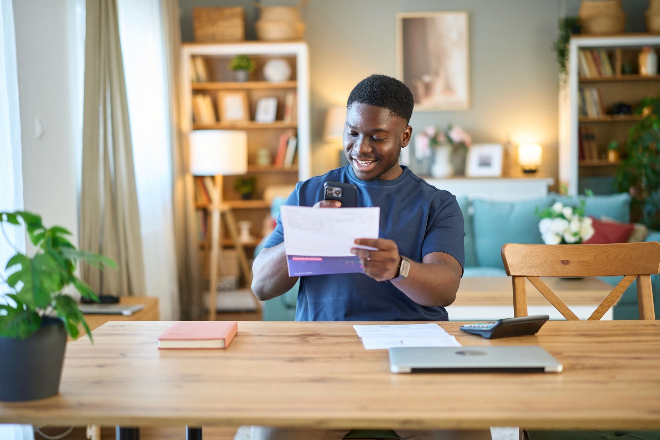 Man smiling with tablet in home office