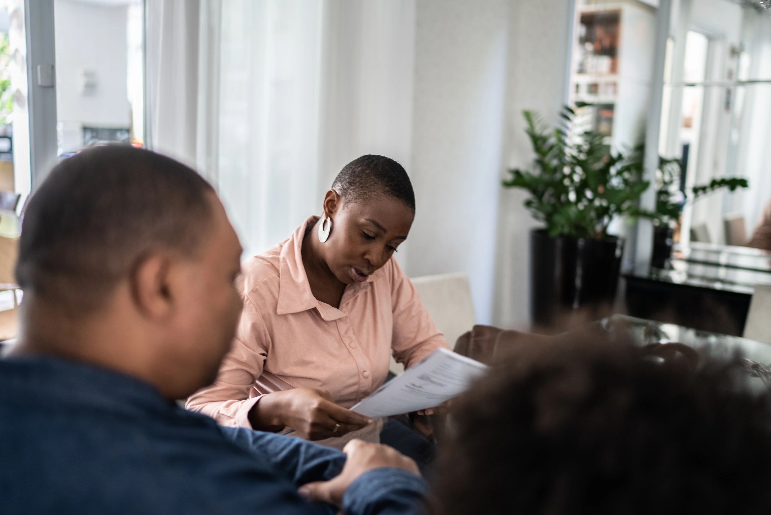 Woman reviewing documents with office colleagues